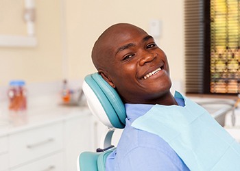 Man smiling after getting implant dentures in South Windsor