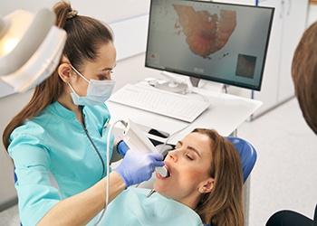 Dentist and patient reviewing X-ray on tablet