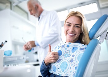 patient giving a thumbs-up at her dental checkup and cleaning in South Windsor 