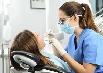 dental hygienist cleaning a patient’s teeth 