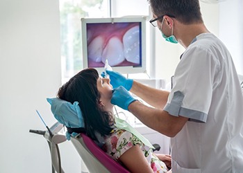 dentist using an intraoral camera on a patient 