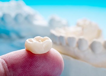 close up of dental crown on someone’s finger