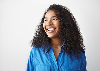 Portrait of happy, smiling woman dressed in blue shirt
