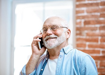 Cheerful senior man talking on phone