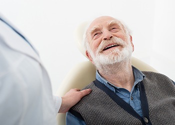 Senior man smiling at his dentist