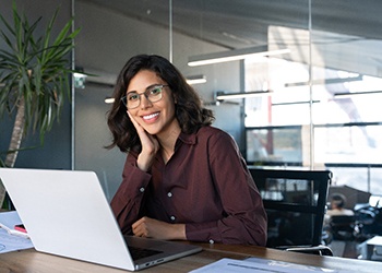 Confident businesswoman sitting at her computer