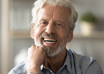 man smiling after paying cost of dentures in South Windsor