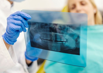 Dentist and patient looking at X-ray together