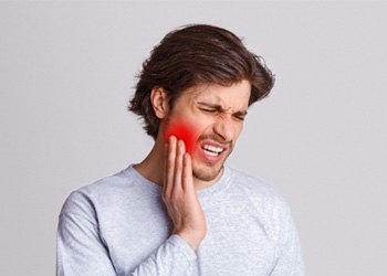 man holding his mouth 