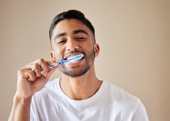 man brushing his teeth