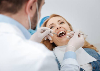 Senior woman receiving dental exam