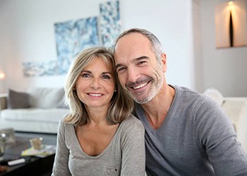 older couple smiling with dental implants in South Windsor