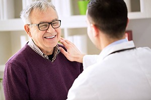 elderly man talking to his dentist