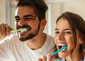 Couple brushing teeth