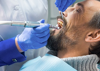 Older man receiving dental treatment