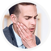 Man in pain holding jaw