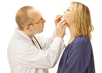 Dentist checking fit of oral appliance