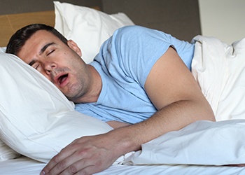 Man in bed snoring