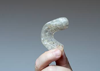 Hand holding an occlusal splint