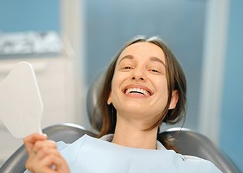 Dentist and patient looking at scan of patient’s teeth