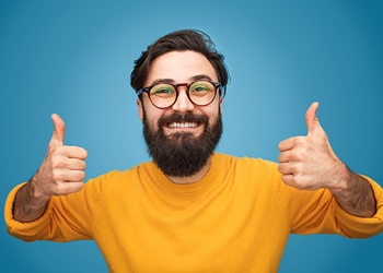 Man smiling with thumbs up 