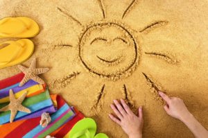 Smiling sun in sand