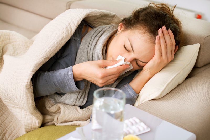 A sick woman lying in bed.