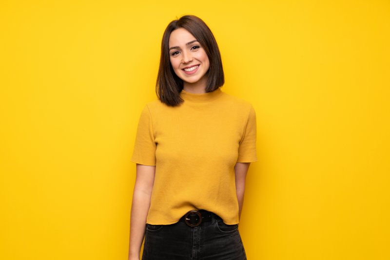 person with dental crown smiling