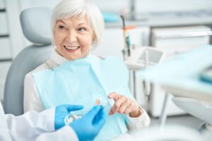 Smiling patient speaking to dentist during consultation 