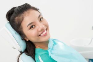 Happy, smiling patient in dental treatment chair